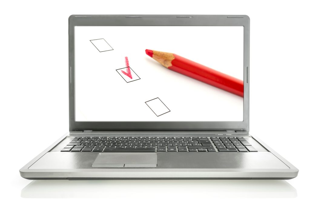 Laptop screen with red pencil and checkmark