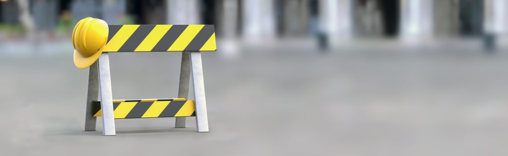 Construction barrier with a yellow hat